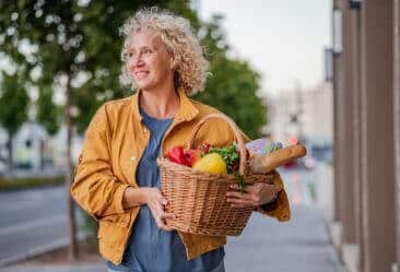picture of woman with a basket full of healthy eating foods