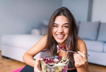 image of a yound woman eating healthy after exercising
