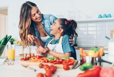 image of mother and daughter in the kitchen cooking a plant-based recipes
